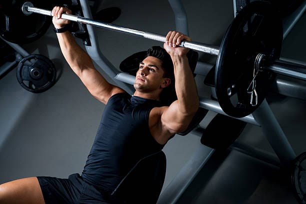 man performing a bench press